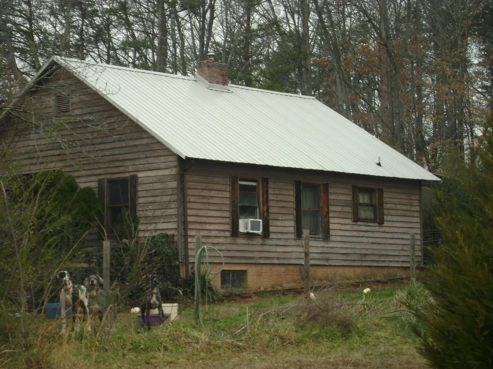 White metal roof on an old wood sided farmhouse, from a Metal Roof Installation job in Marsteller